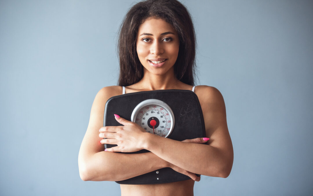 Fit woman holding a scale