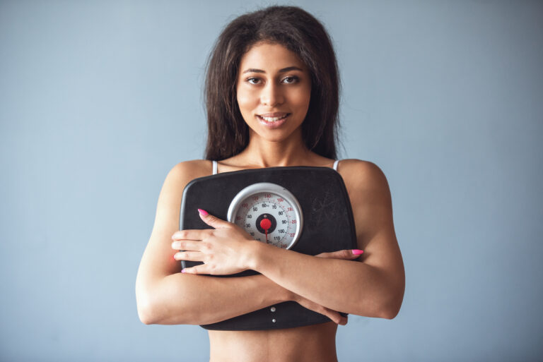 Fit woman holding a scale